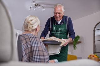 a man and a woman holding a tray of food