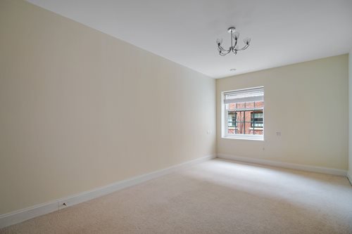 a room with a window and a carpet