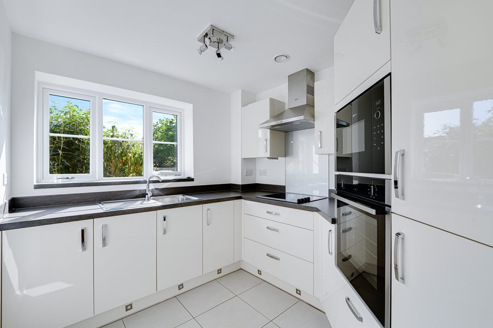 a kitchen with white cabinets
