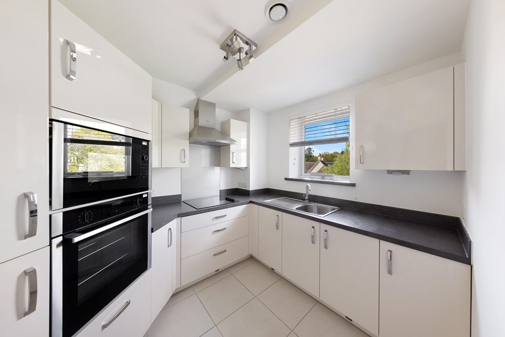 a kitchen with white cabinets