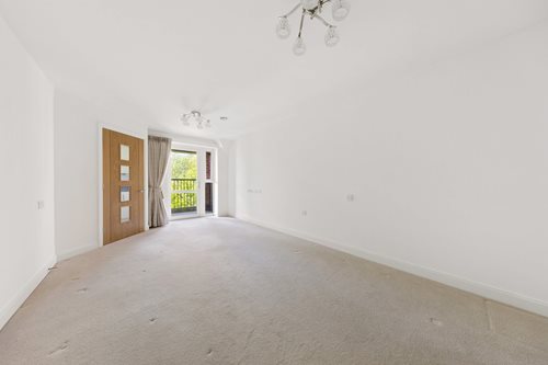 a hallway with a door and windows