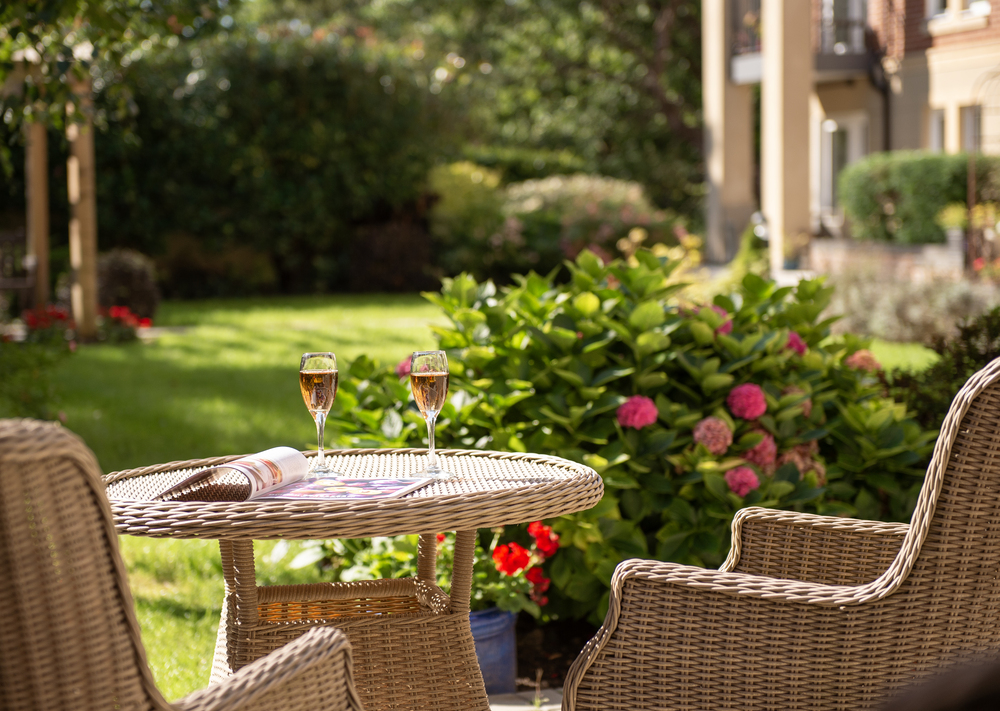 a table with wine glasses and flowers on it