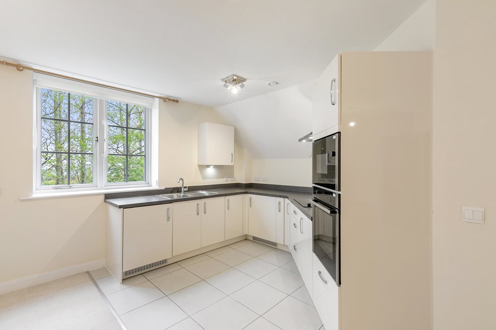 a kitchen with white tiles