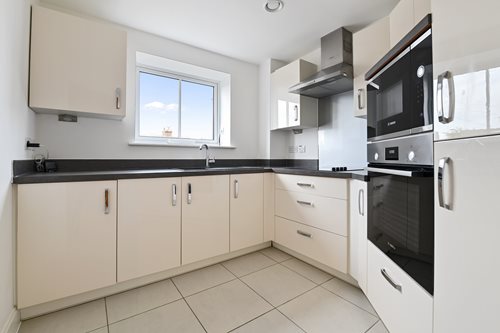 a kitchen with white cabinets