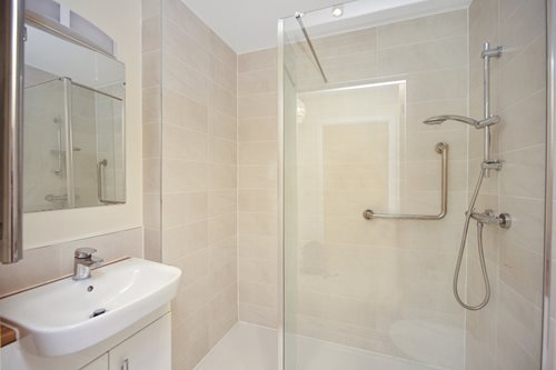 a bathroom with a shower and sink