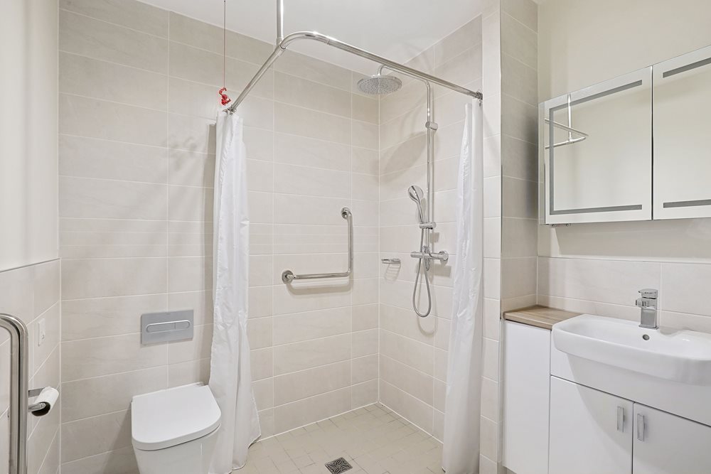 a bathroom with a shower unit and sink