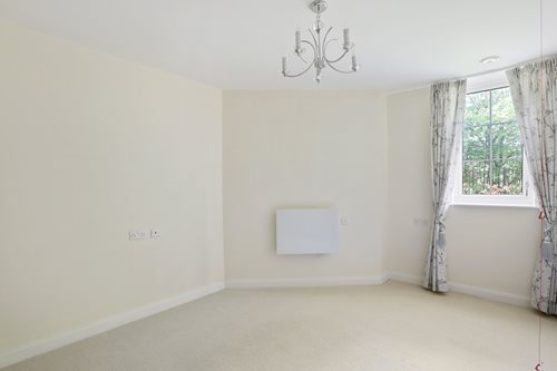a room with a chandelier and a window