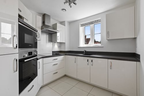a kitchen with white cabinets