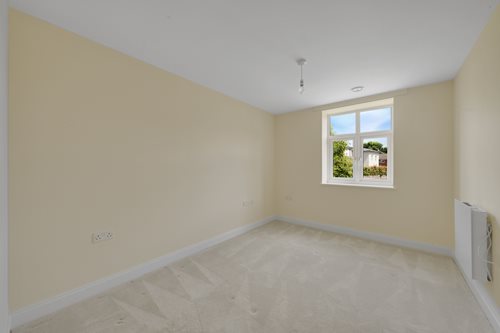 a room with a window and a carpet
