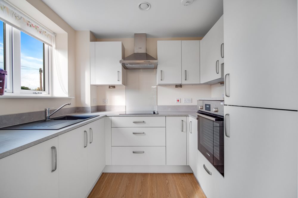 a kitchen with white cabinets