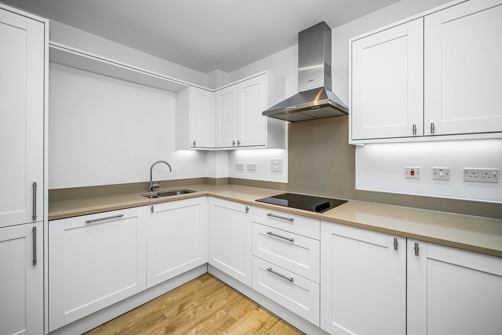 a kitchen with white cabinets