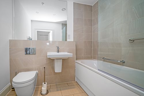 a bathroom with a tub sink and toilet