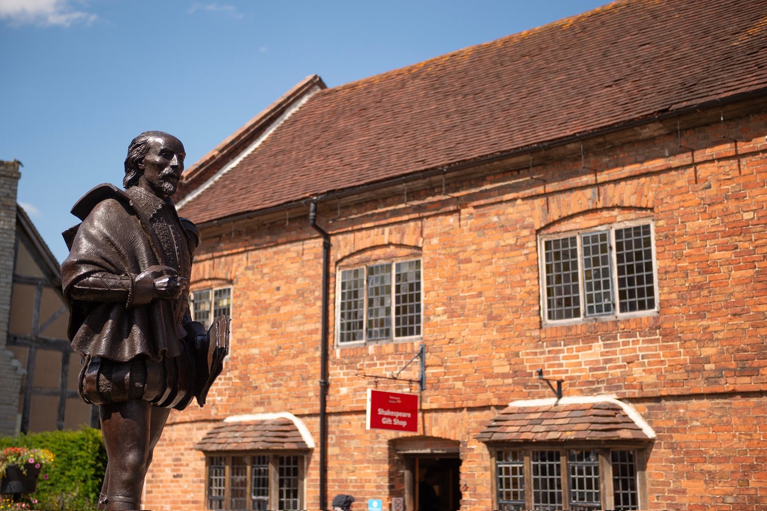 a statue in front of a brick building