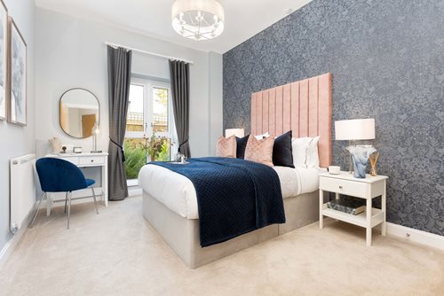 a bedroom with a bed and a desk