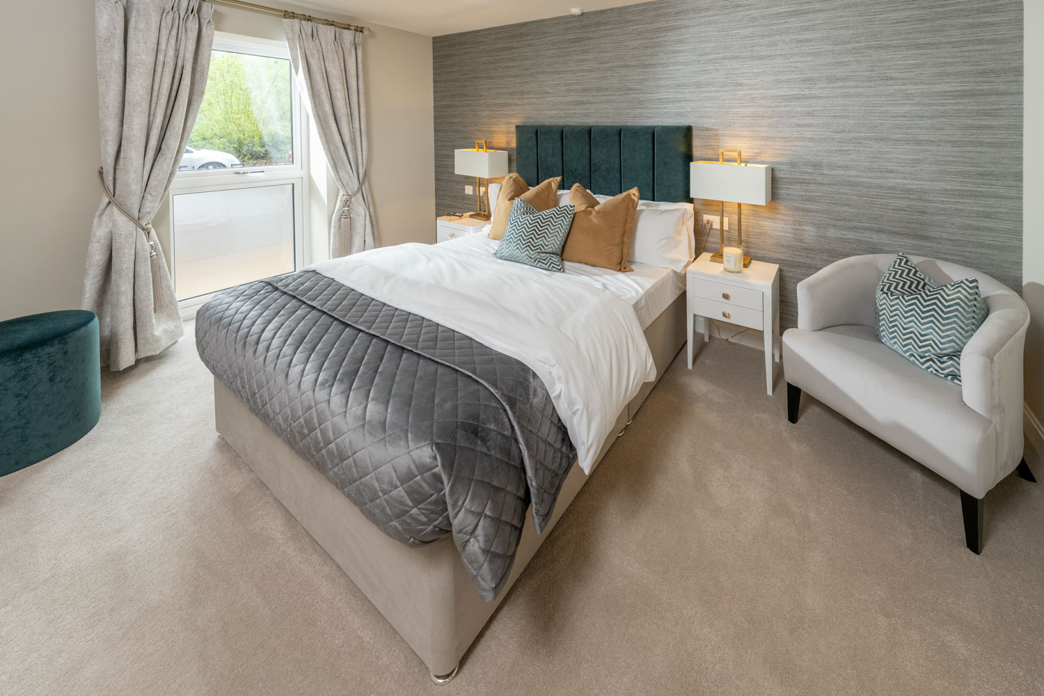 a bedroom with a bed and chairs