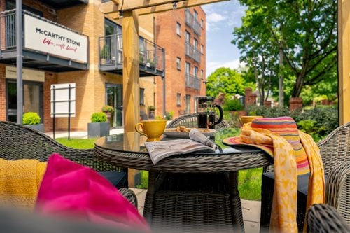a table outside with chairs and a basket on it