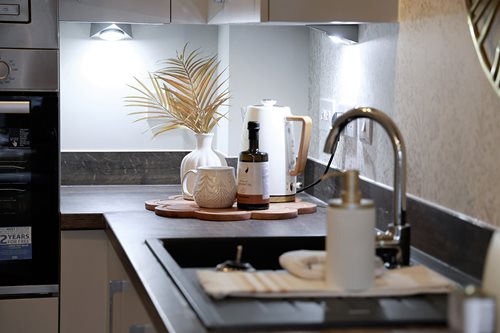 a kitchen counter with a vase and a potted plant