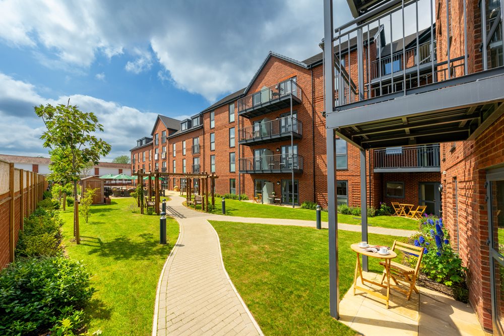 a building with a walkway and grass