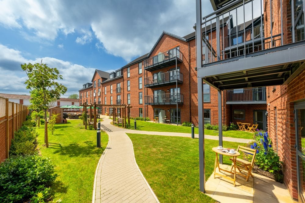 a building with a walkway and grass