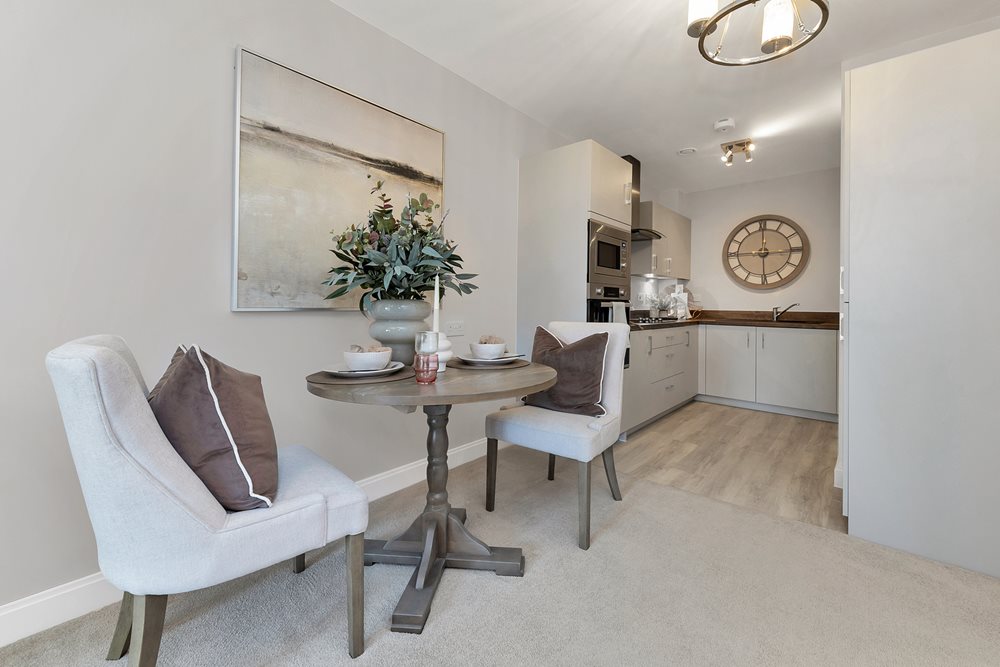 a living room with a table and chairs