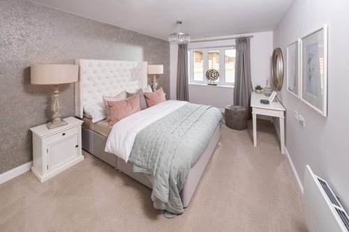 a bedroom with a bed and lamps