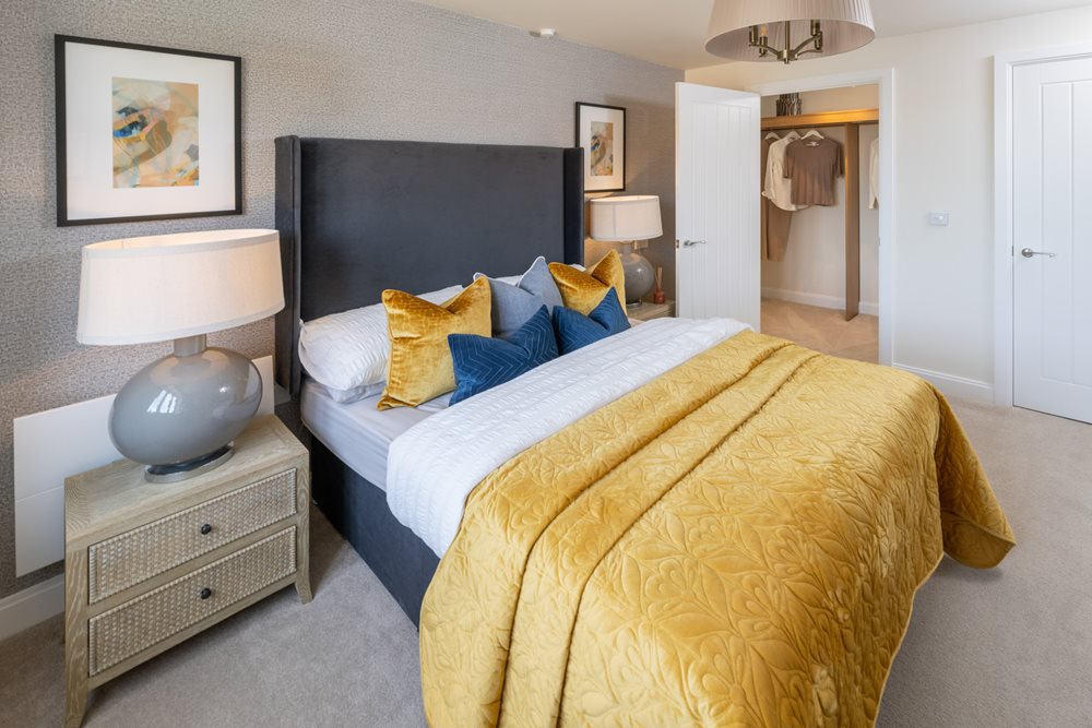 a bedroom with a bed and lamps