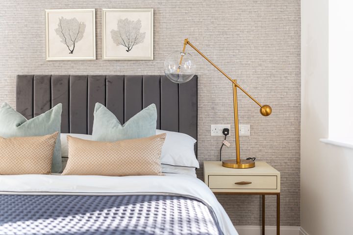 a bed with a lamp on the side