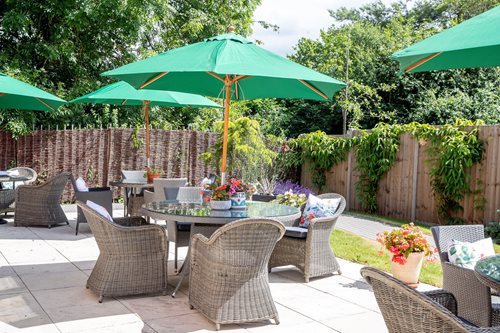 a patio with chairs and umbrellas