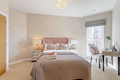 a bedroom with a bed and a desk