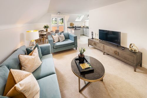 a living room with a tv and couches
