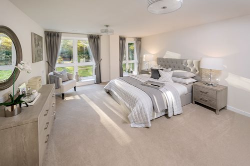 a bedroom with a bed and a chair