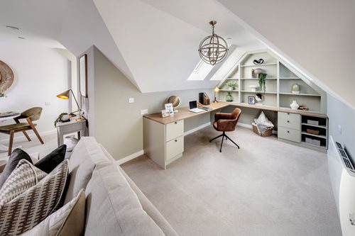 a living room with a desk and chair