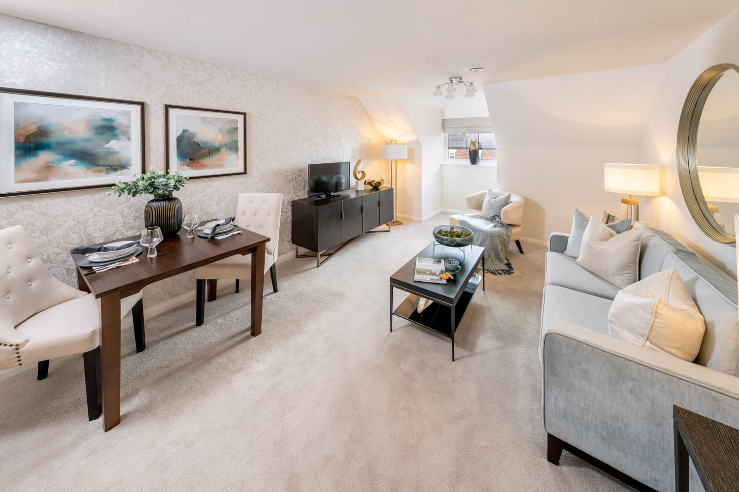 a living room with a table and chairs