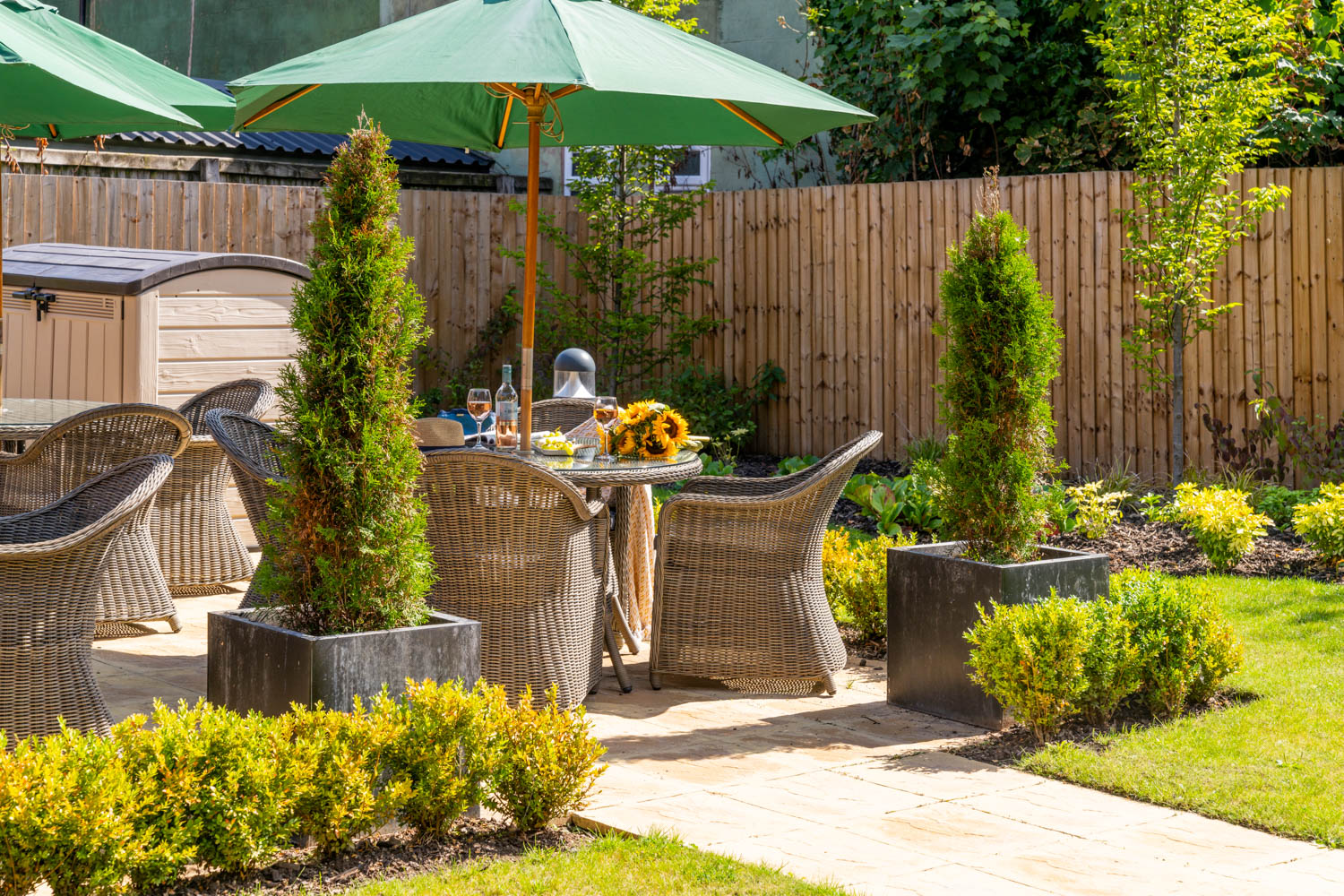 a patio with a table and chairs and umbrella