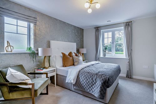 a bedroom with a bed and a chair