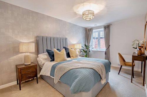 a bedroom with a bed and a table
