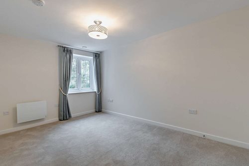 a room with a window and curtains