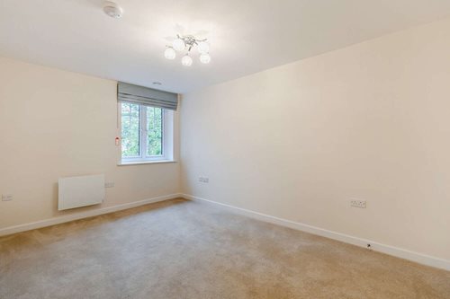 a room with a window and a carpet