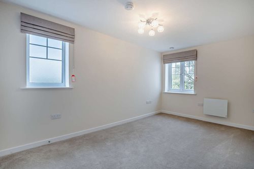 a room with a window and a light on the ceiling