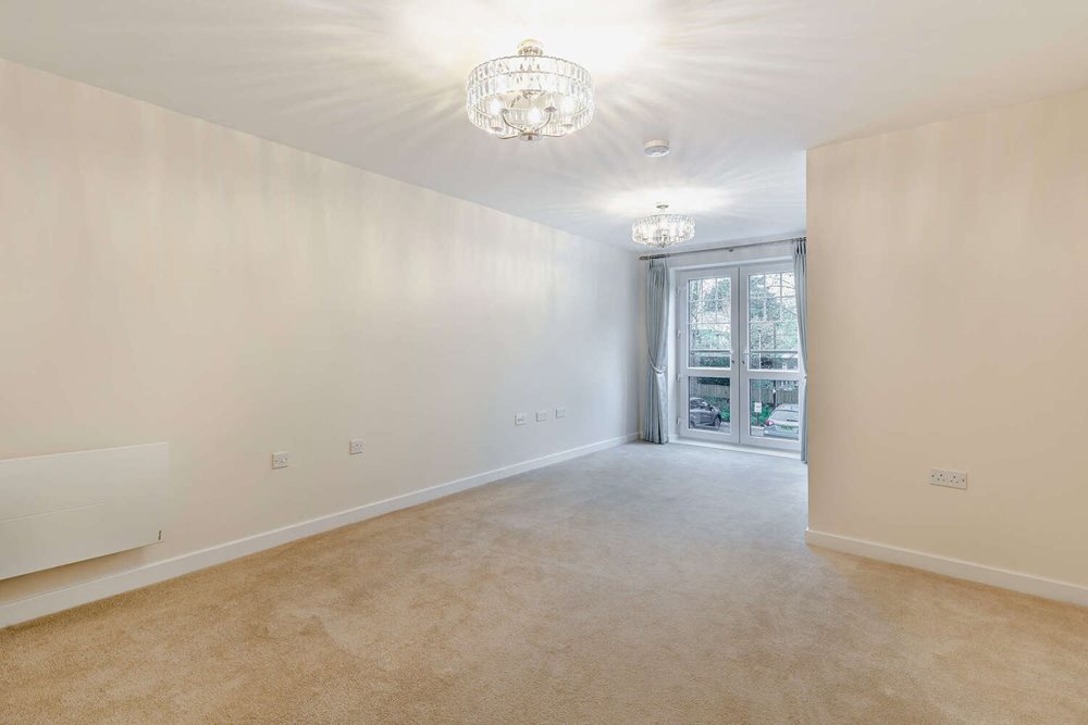 a room with a ceiling fan and a carpet