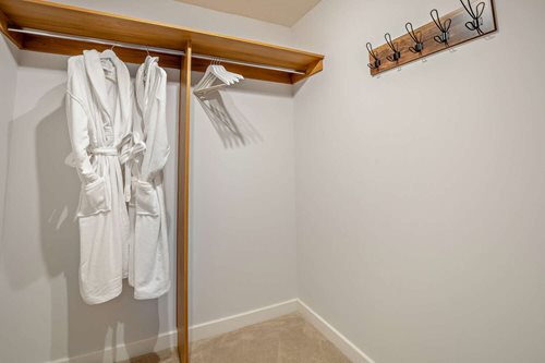 a row of white dresses on a wall