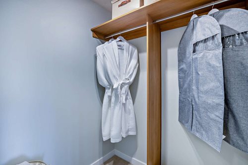 a pair of white shirts on a wooden rack