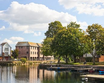 a body of water with boats and buildings along it