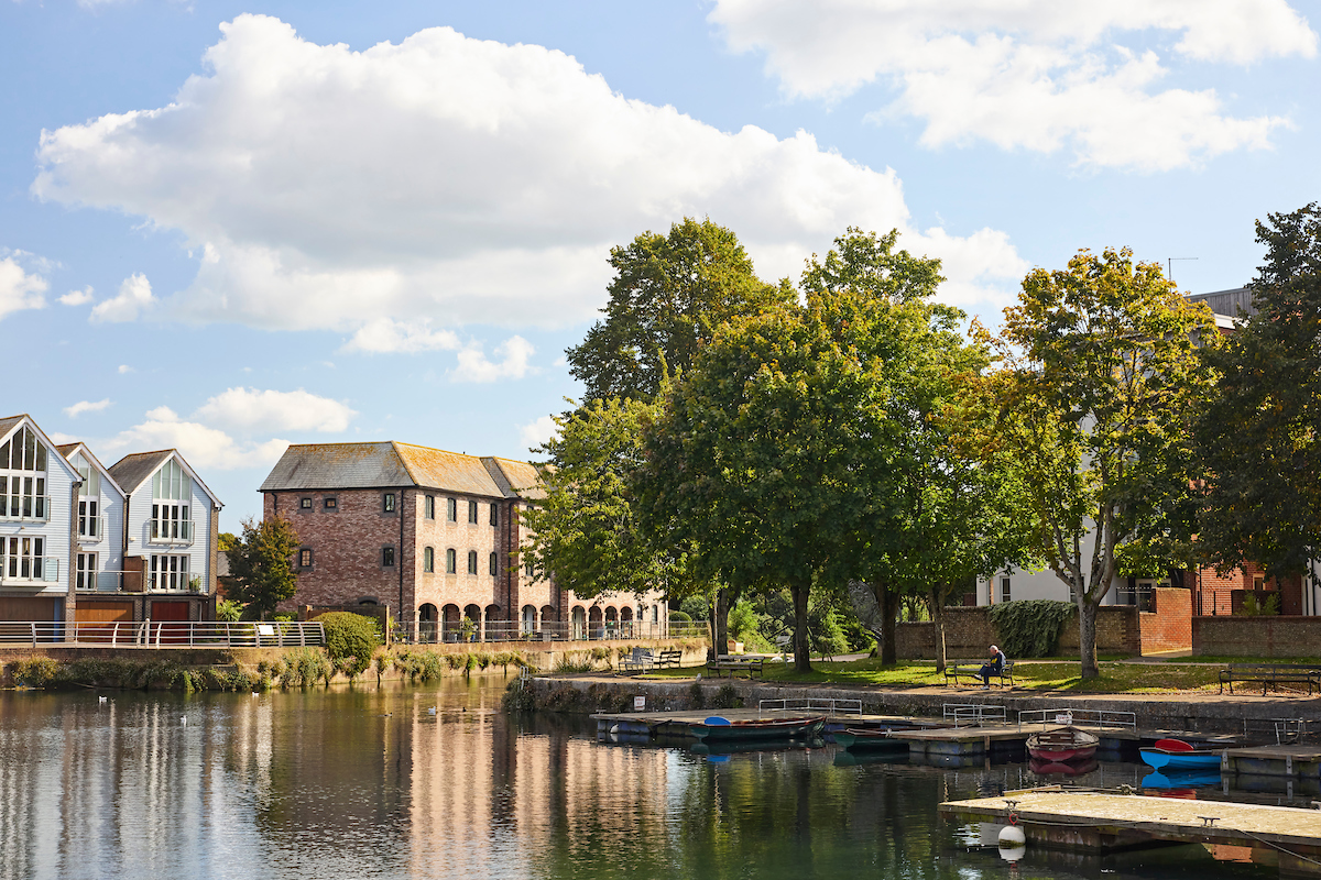 a body of water with boats and buildings along it