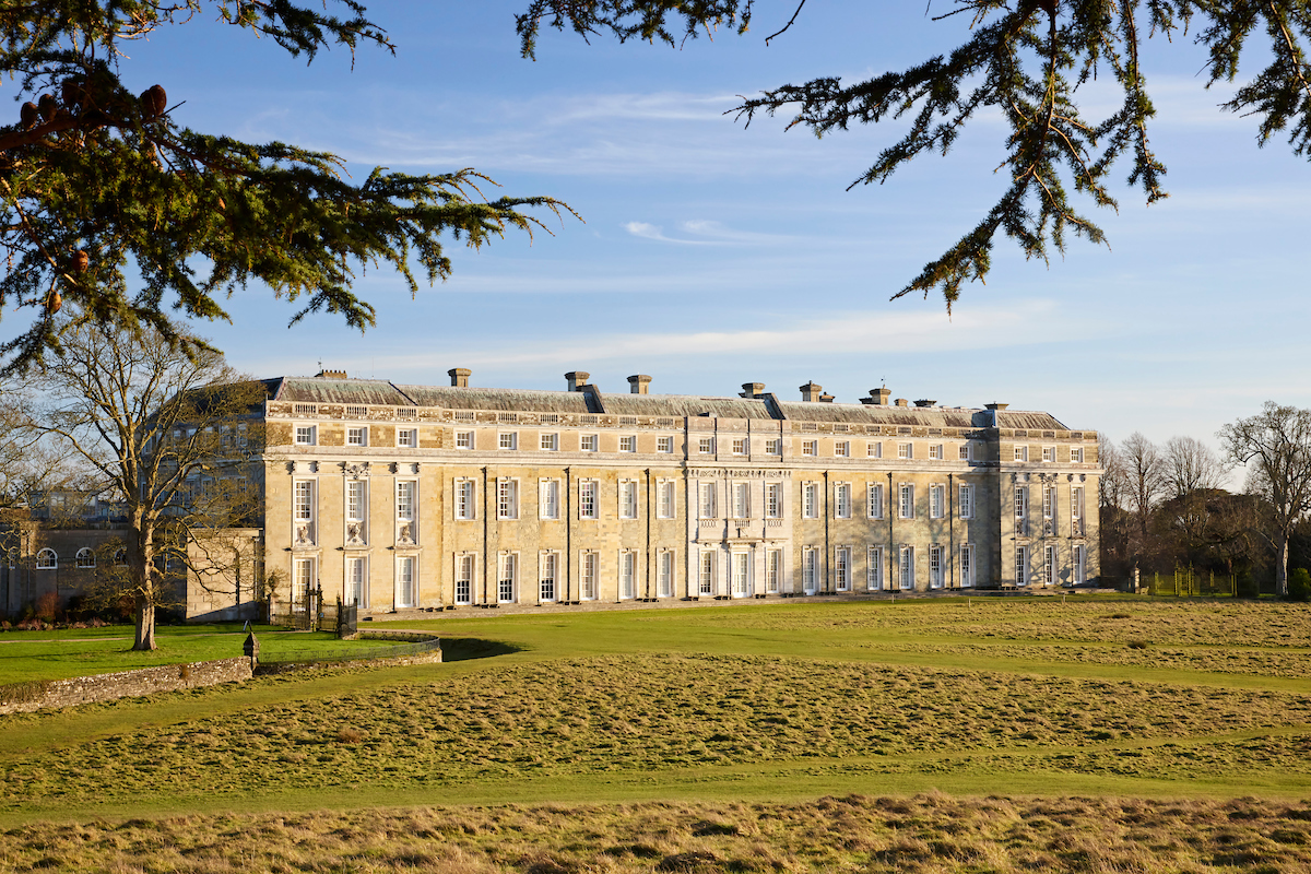 a large building with a lawn in front of it