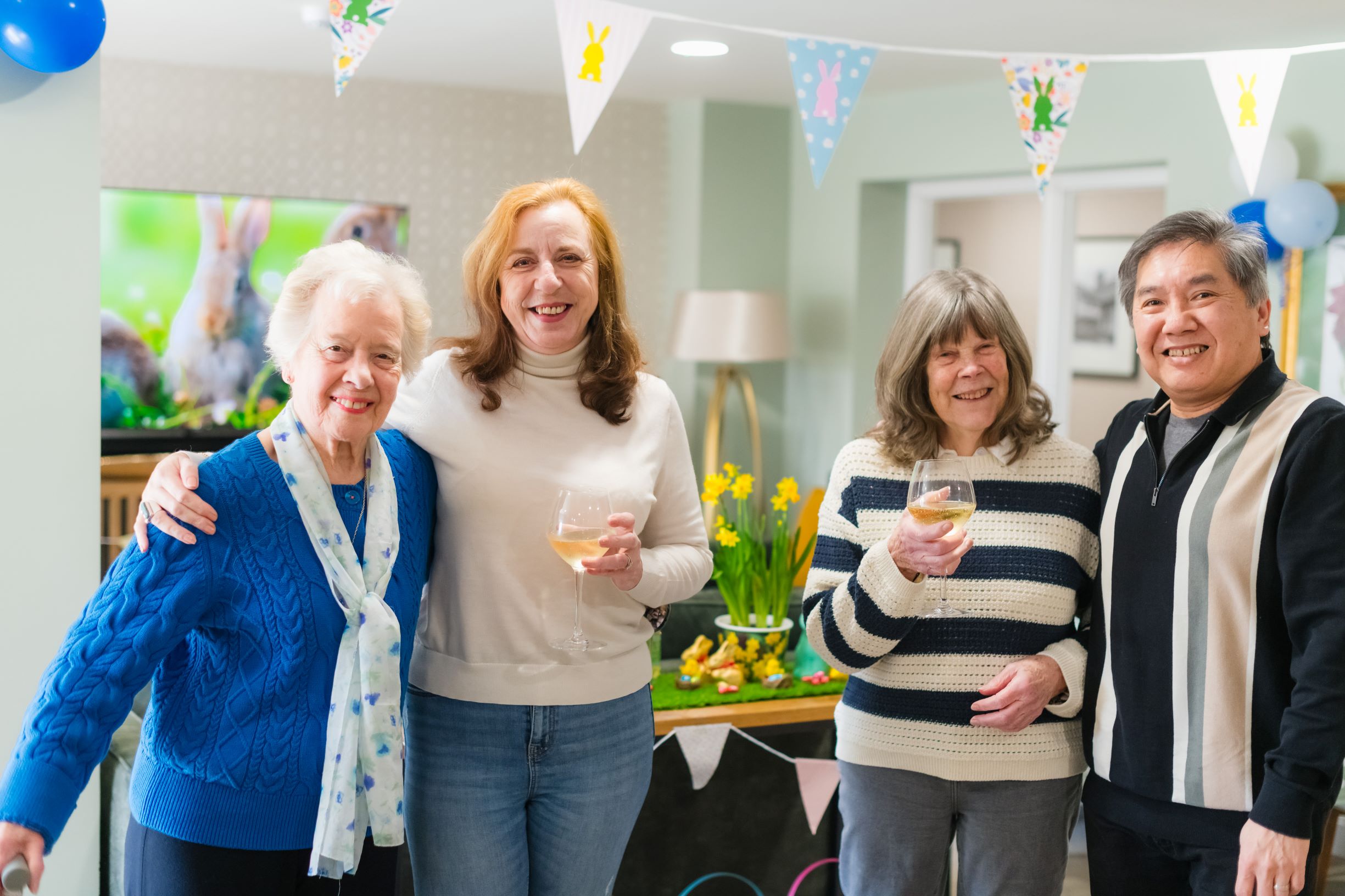 a group of people holding wine glasses
