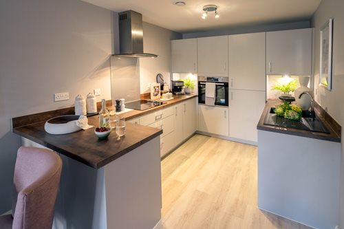 a kitchen with a bar and chairs