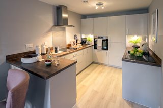 a kitchen with a bar and chairs