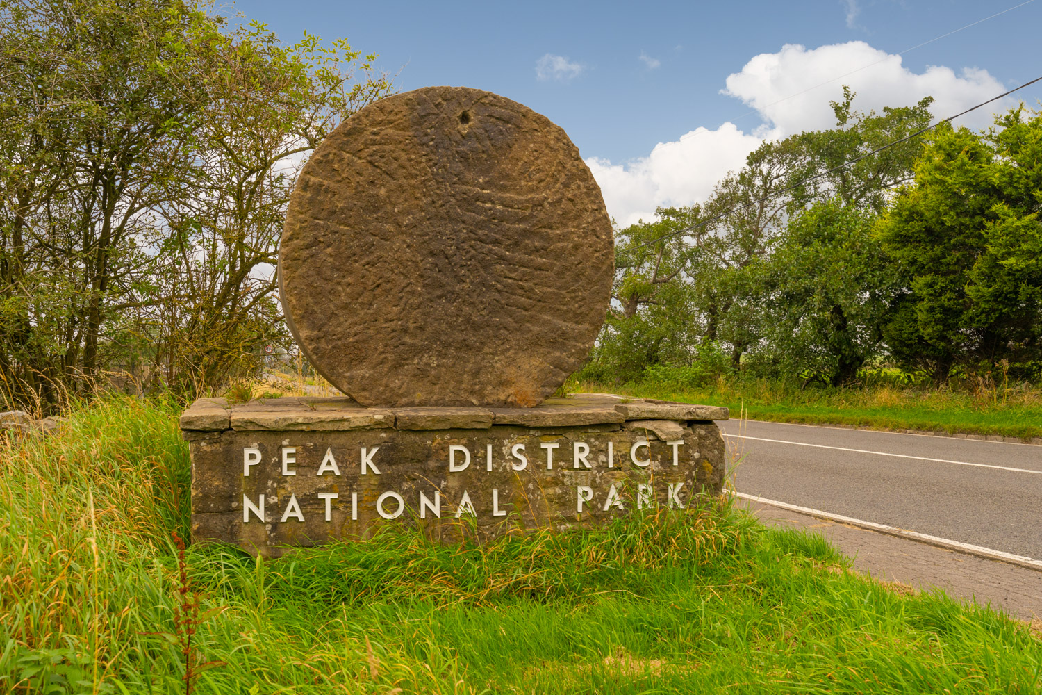 a large stone structure next to a road