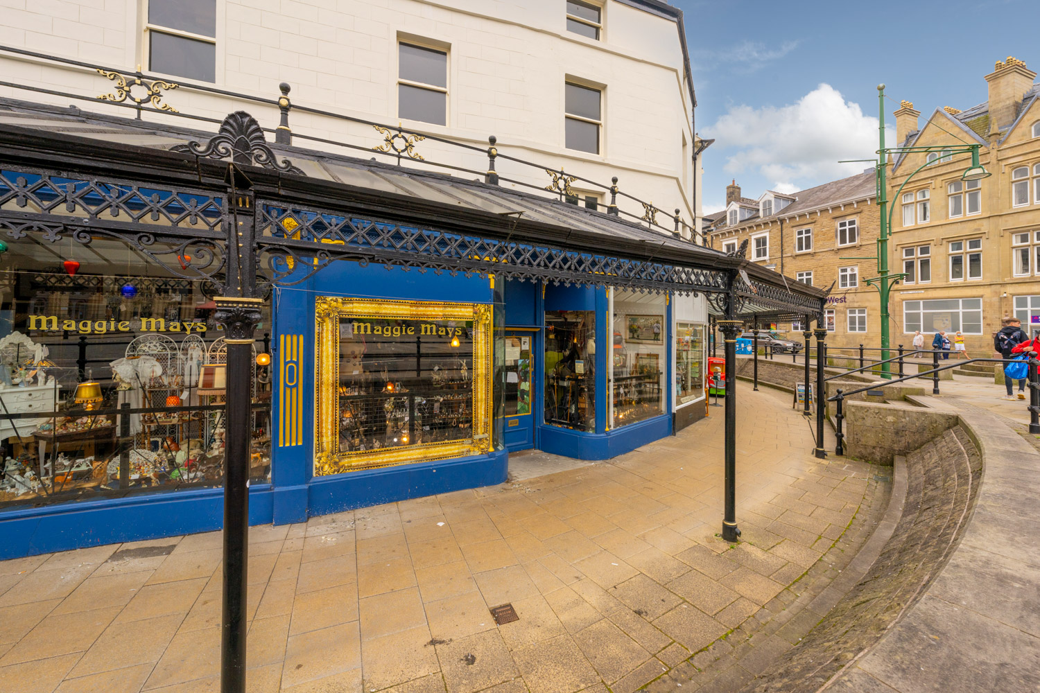 a blue and white building with a blue awning and a blue awning